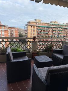 a patio with chairs and tables on a balcony at #Punto FM 6# in Marghera