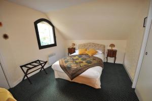 a bedroom with two beds and a window at La Chaumière Roz-Aven in Pont-Aven