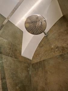 a bathroom with a mirror and a tiled floor at Appartamento Jazz 1 in Muralto +1 photo