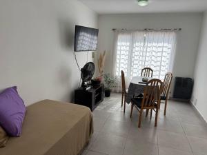 a bedroom with a bed and a table and chairs at Serranias de Tandil in Tandil