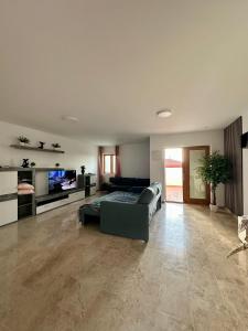 a large living room with a couch and a tv at VILLA CHRIS Ocean View in La Jaca