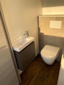 a bathroom with a sink and a toilet at pontons view residence in Saint-Côme-de-Fresné +40 photos