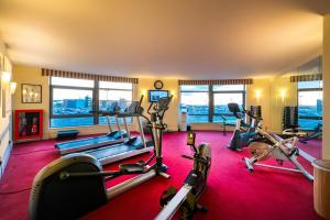 a gym with several treadmills and exercise bikes at Cork International Hotel in Cork