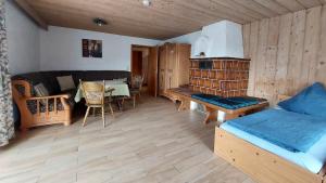 a living room with a couch and a dining room at Ferienwohnung Nr 1, Lechbruck-Gründl, Allgäu in Prem
