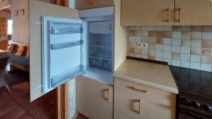 an empty kitchen with an empty refrigerator in it at Ferienwohnung Nr 4, Lechbruck-Gründl, Allgäu in Prem