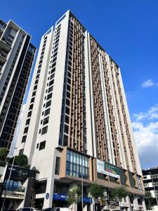 a tall building with windows on a city street at Sky Trees Bukit Indah AEON Netflix A16 in Johor Bahru +30 photos
