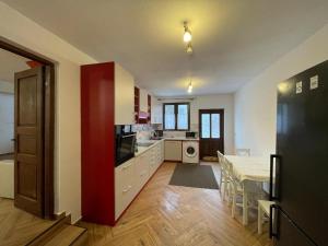 a kitchen and dining room with a table and a dining room at Casa Sofia in Băile Homorod