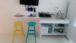 a kitchen with two stools and a counter with a sink at 805 Vista Mar Aconchegante in Salvador