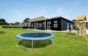 a blue trampoline in a yard with a playground at Four-Bedroom Holiday Home In Haderslev in Store Anslet