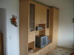 a living room with a tv and a cabinet at Ferienwohnung Nr 7, Meersburg, Bodensee in Meersburg