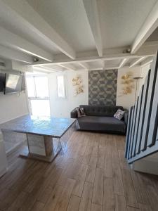 a living room with a couch and a glass table at T3 Duplex, centre port, clim, garage, piscine in Cap d'Agde