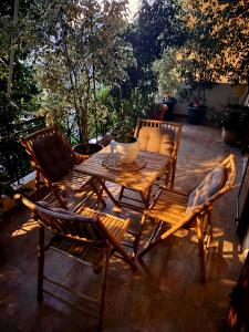 a wooden table and chairs on a patio at Jasmine place in Kalamata