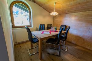 a dining room with a wooden table and chairs at Huberhof 10 by Alpenidyll Apartments in Rohrmoos