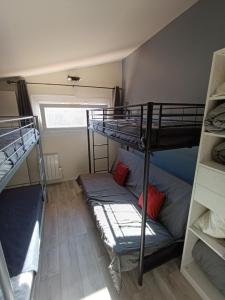 a bunk bed and a couch in a room at T3 Duplex, centre port, clim, garage, piscine in Cap d'Agde +26 photos