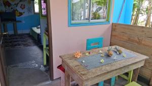 a wooden table with seashells on top of it at Rapa Nui Oficial in Hanga Roa