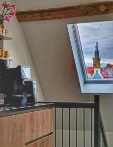 a kitchen with a window with a view of a clock tower at Dream Boutique Edam Coffee & Comfort in Edam +30 photos