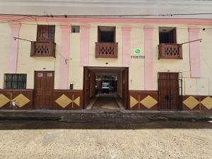 a large building with wooden doors and windows at HOSPEDAJE ALVARADO - Matrimonial - 301 - Bueno Bonito y Barato in Cajamarca