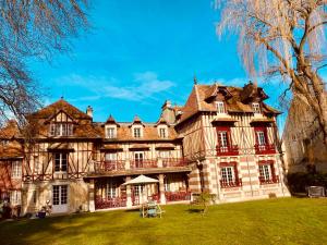 an old house with a yard in front of it at Manoir des Étangs in Croissanville
