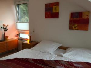 a bedroom with a white bed and a window at Brühl, FeWo am Heider Bergsee - 3 Sterne DTV in Brühl