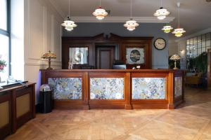 a lobby with a wooden counter with a window at Kilkenny House Boutique Hotel in Kilkenny +81 photos