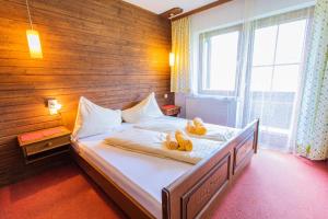 a bedroom with a bed with towels on it at Huberhof 6 by Alpenidyll Apartments in Rohrmoos