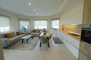 a kitchen and living room with a couch and a table at Comfort Stay Villas in Kastoria