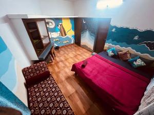 an overhead view of a bedroom with a bed and a mural at Happy Home Varkala in Varkala