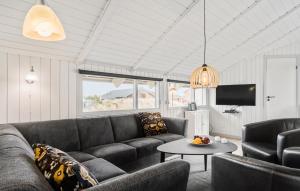 哈夫維格Holiday Home Kr Madsens Vej Hvide Sande Denm的客厅里有一张沙发和一张桌子。