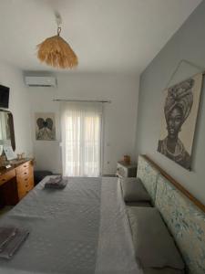 a bedroom with a bed and a painting on the wall at Villa Kampou in Leptokaria +137 photos