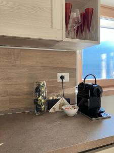a kitchen counter with a mixer and a bowl of food at Maison Doél in Ragoli +27 photos