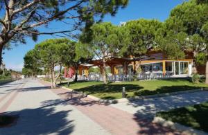 a house on the side of a street with trees at Gjiri I Lalzit apartament in Durrës