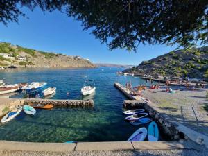 a group of people on a beach with boats in the water at RELAXED PLACE by the sea in Cesarica
