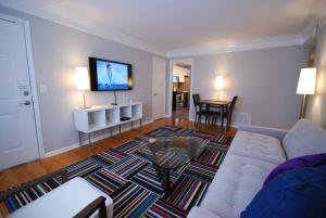 a living room with a couch and a flat screen tv at Brookwood Courtyard by BCA Furnished Apartments BCC1B 06 F in Atlanta