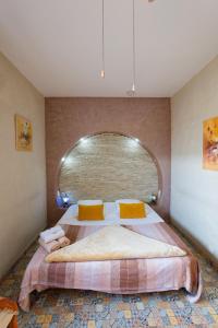 a bedroom with a large bed with a large window at Riad Les Chtis D'Agadir in Agadir +37 photos