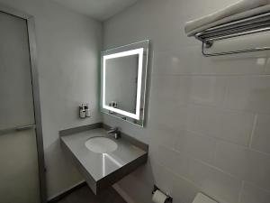 a bathroom with a sink and a mirror at Hotel Unico in Mexico City