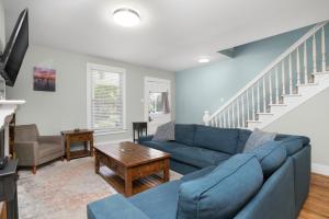 a living room with a blue couch and a table at Bayside - Classic duplex in historic downtown! in Cape Charles