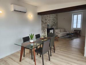 Un comedor con mesa y sillas y una sala de estar. en L'Inattendu, en Pornic