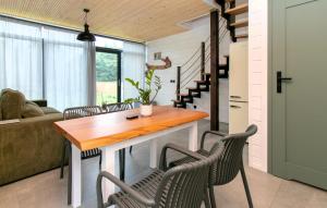 a living room with a wooden table and chairs at Beautiful Home In Potolowek With Sauna in Potołówek