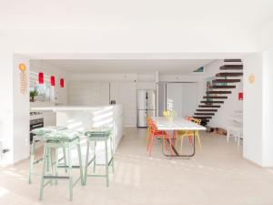 a kitchen with a table and chairs and a staircase at CasaSol Deluxe villa sulla Spiaggia con Piscina e Jacuzzi By Sicily Home Solutions in Alcamo +59 photos