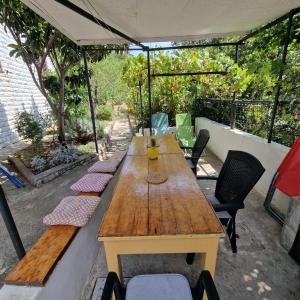 a wooden table and chairs on a patio at RELAXED PLACE by the sea in Cesarica +33 photos