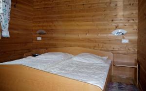 Un pat sau paturi într-o cameră la Ferienhaus Nr 28, Typ A, Feriendorf Jägerpark, Bayerischer Wald