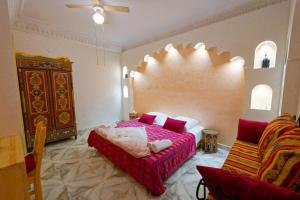 a bedroom with a bed and two chairs in it at Riad Les Chtis D'Agadir in Agadir