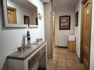 a hallway with a table and a mirror in a room at Hostería VISTAPARK in El Astillero
