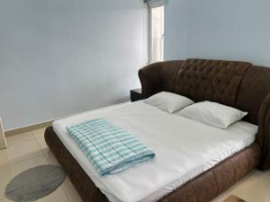 a bed with a blanket on it in a room at Maxim Citylight Jln Sentul paser in Kuala Lumpur +51 photos