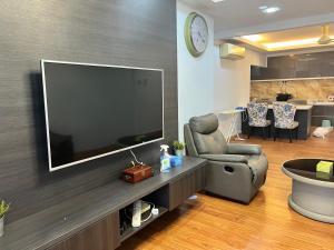a living room with a large flat screen tv on a wall at Maxim Citylight Jln Sentul paser in Kuala Lumpur