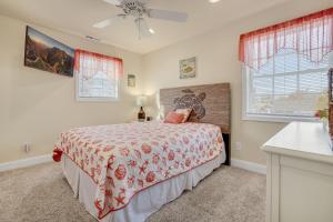 a bedroom with a bed and two windows at Beach Haven - Modern Home; Close to town! in Chincoteague