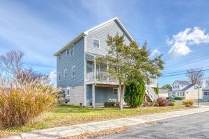 a gray house with a balcony on a street at Beach Haven - Modern Home; Close to town! in Chincoteague