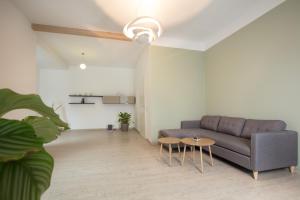 a living room with a couch and a table at Ferienwohnung Naturzeit Lauscha in Lauscha