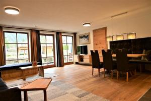 a living room with a dining room table and chairs at Apartment Grubigstein in Biberwier