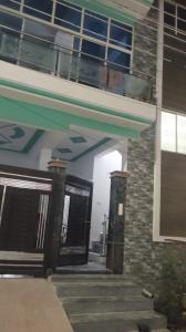 an entrance to a building with doors and a balcony at home stay IIIT chauraha near subedargunj railway station in Prayagraj